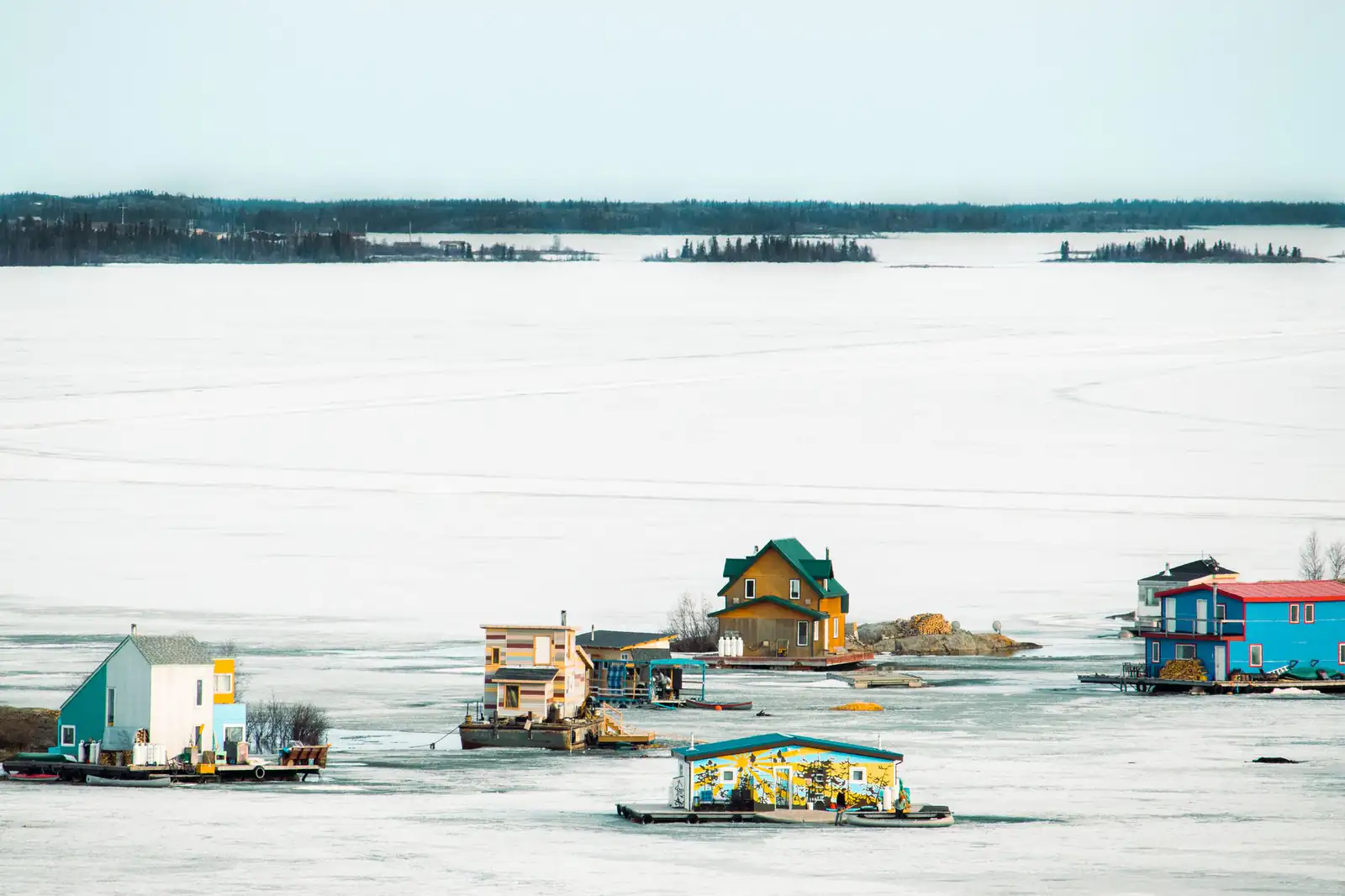 Colourful houseboats on the frozen bay at Yellowknife in winter
